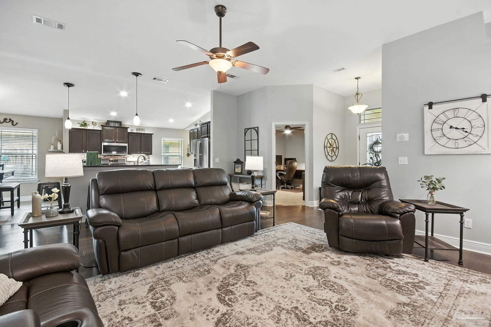2587 Fiddlers Circle Cantonment, FL 32533 - Photo 12 of 66 a living room with furniture and a chandelier