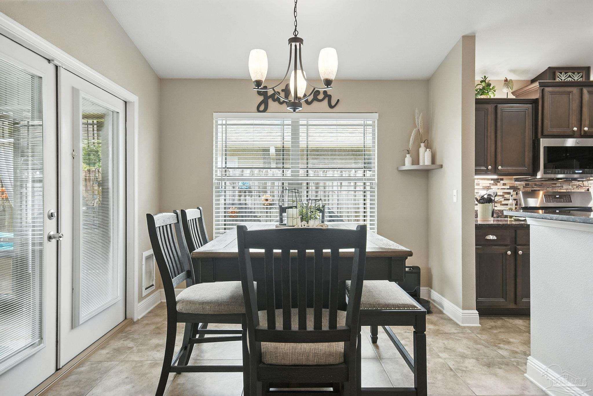2587 Fiddlers Circle Cantonment, FL 32533 - Photo 18 of 66 a view of a dining room with furniture window and outside view