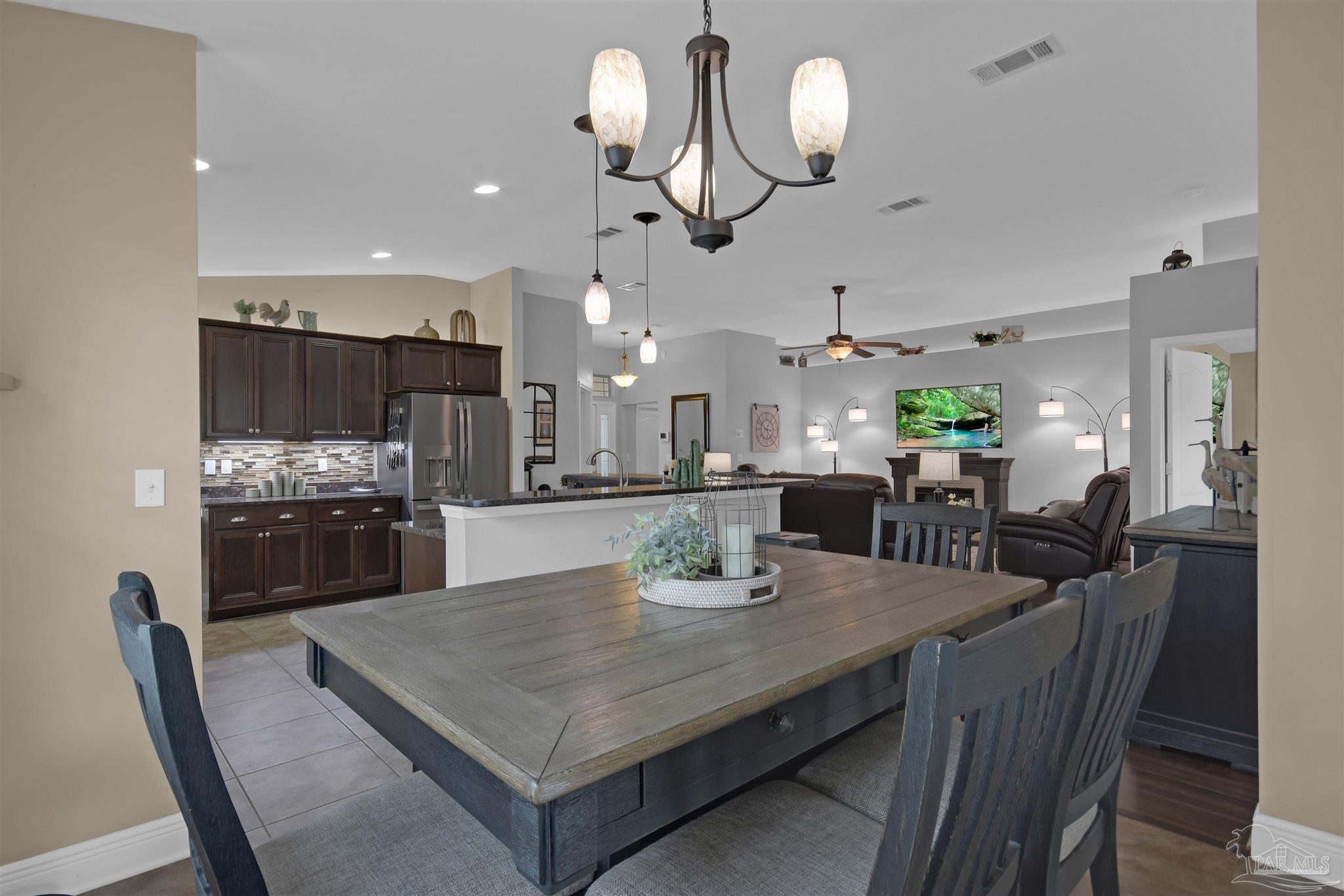 2587 Fiddlers Circle Cantonment, FL 32533 - Photo 19 of 66 a view of a dining room with furniture and wooden floor