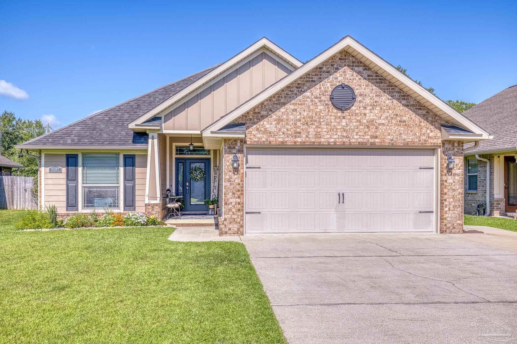 2587 Fiddlers Circle Cantonment, FL 32533 - Photo 2 of 66 a front view of a house with a yard