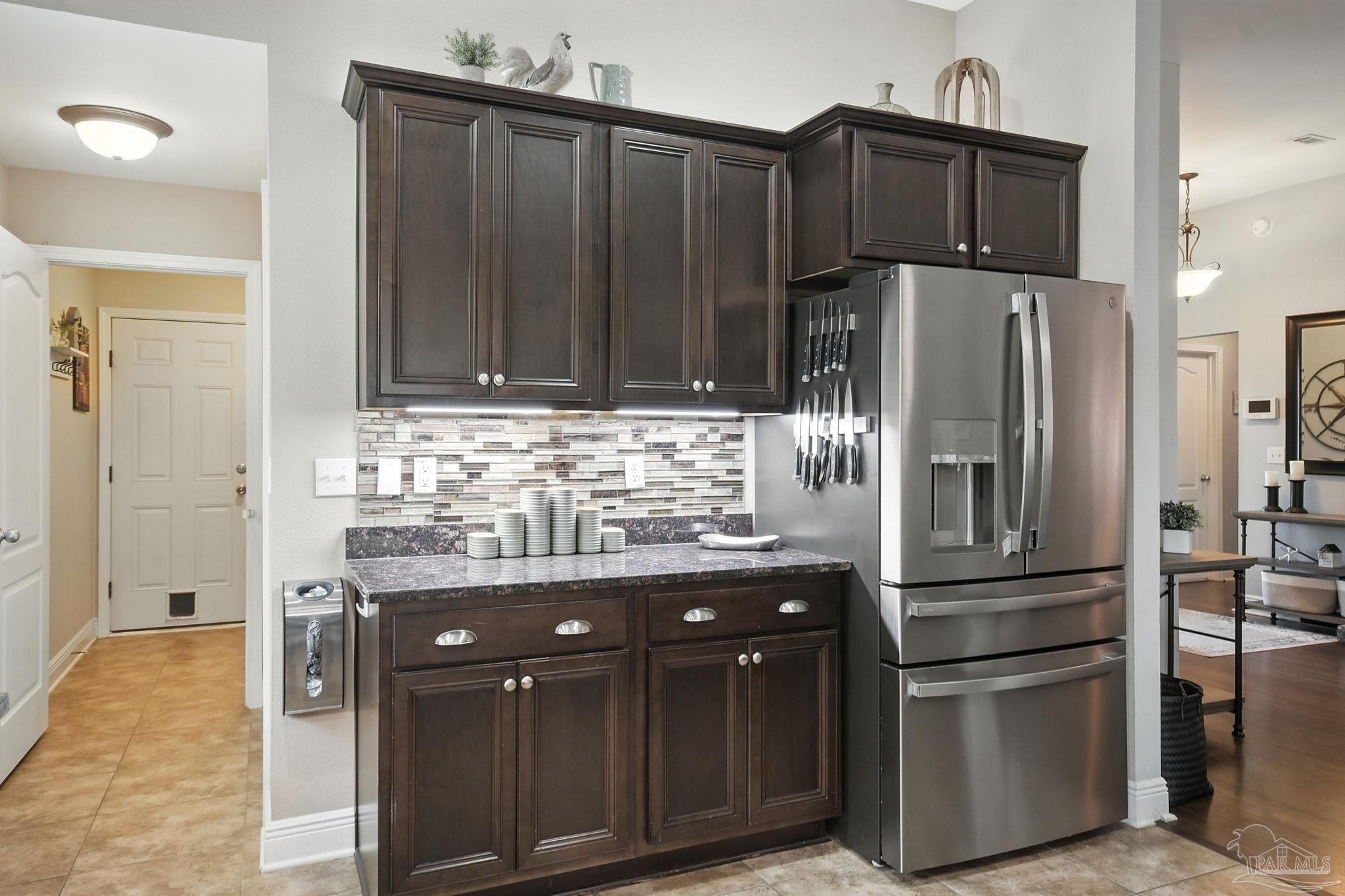 2587 Fiddlers Circle Cantonment, FL 32533 - Photo 21 of 66 a kitchen with stainless steel appliances granite countertop a refrigerator and a stove