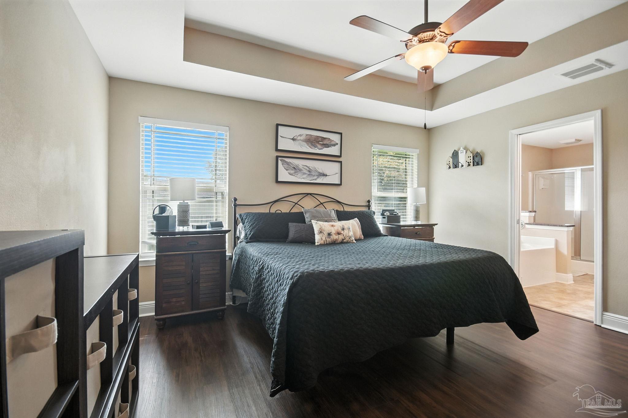 2587 Fiddlers Circle Cantonment, FL 32533 - Photo 30 of 66 a bedroom with a bed and a chandelier