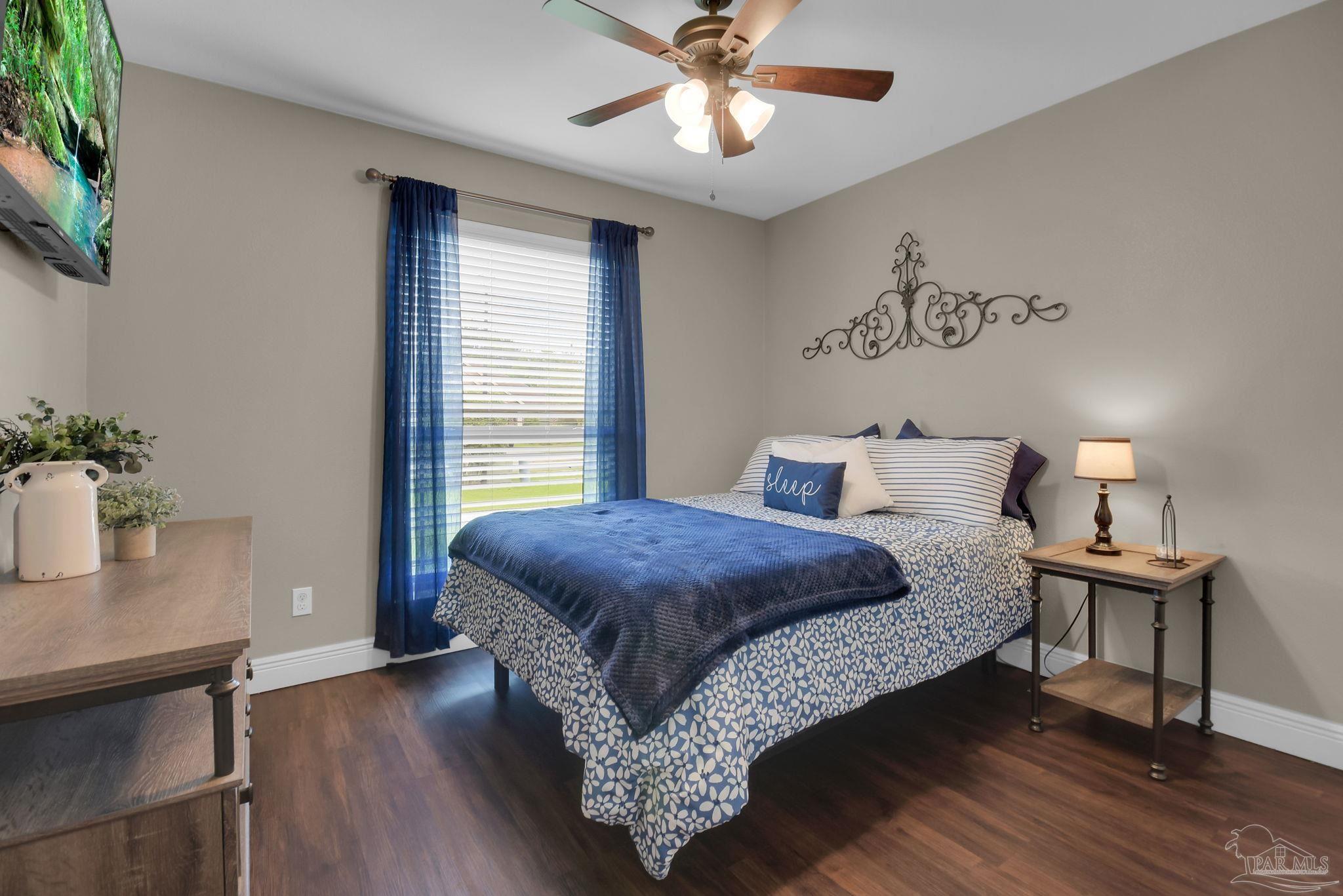 2587 Fiddlers Circle Cantonment, FL 32533 - Photo 38 of 66 a bedroom with a bed and a table