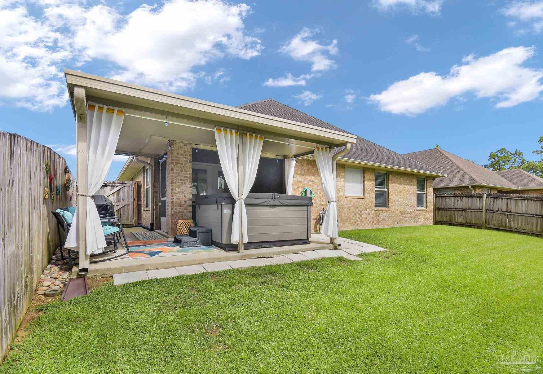2587 Fiddlers Circle Cantonment, FL 32533 - Photo 55 of 66 a front view of a house with a yard