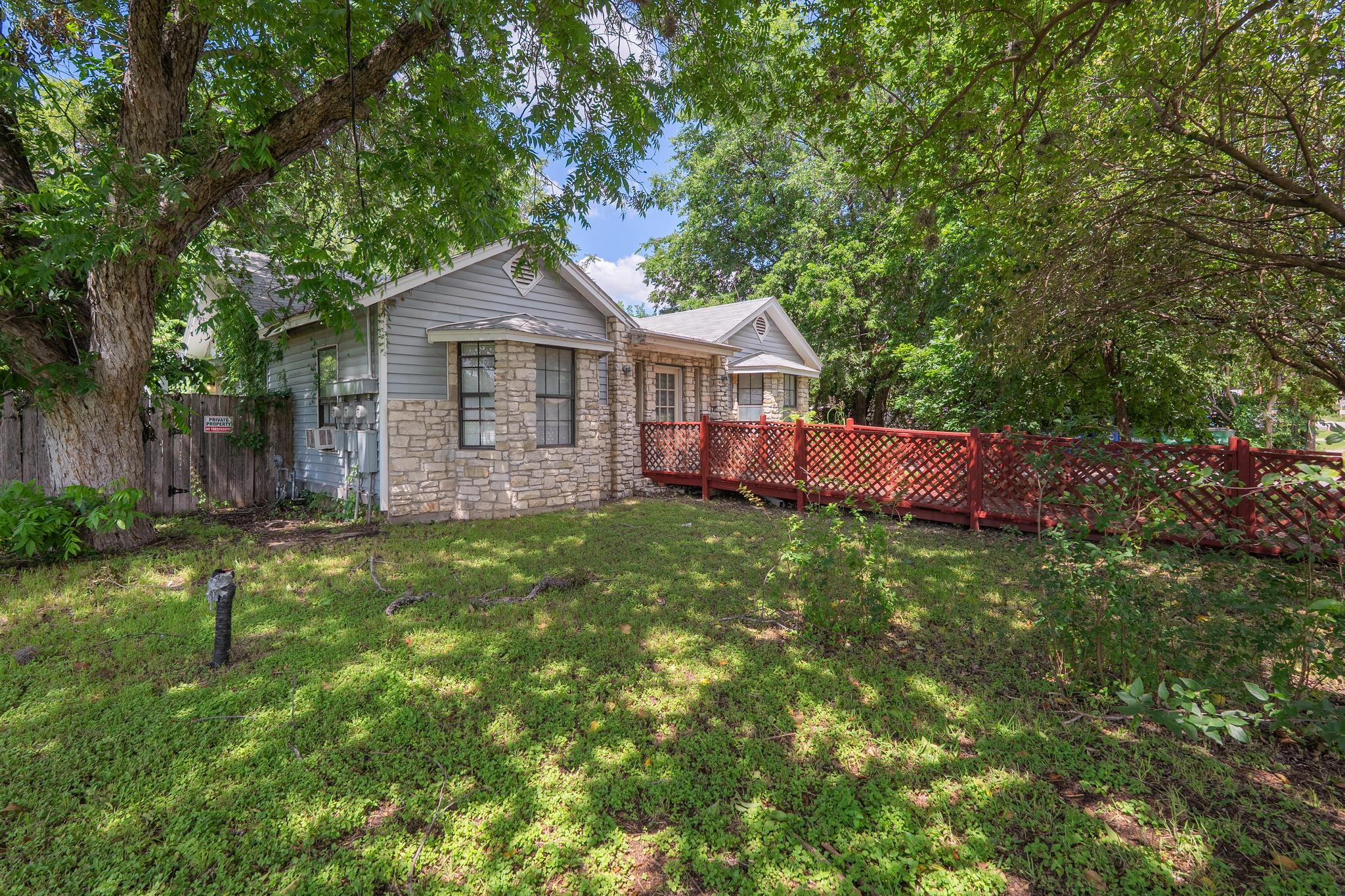 4616 East Cesar Chavez Street Austin, TX 78702 - Photo 2 of 22 a view of a house with a yard and large trees