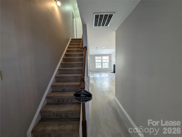 a view of entryway and hall with wooden floor