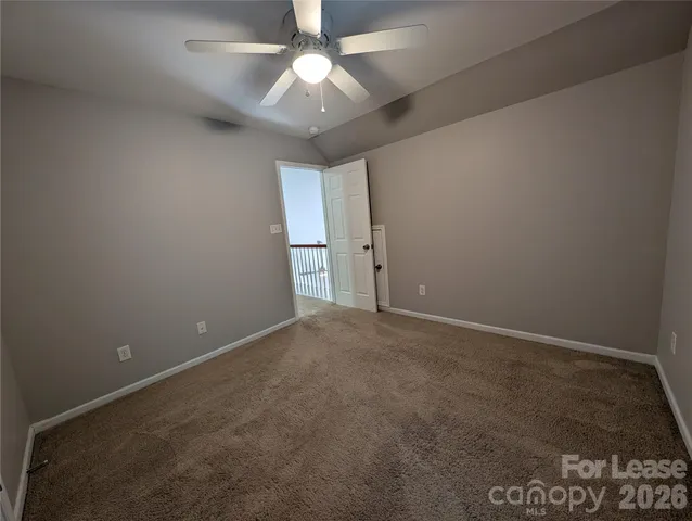 an empty room with a ceiling fan and fan