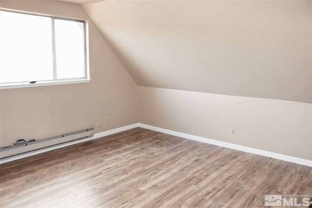 17360 Cold Springs Drive Reno, NV 89508 - Photo 6 of 16 an empty room with wooden floor and windows