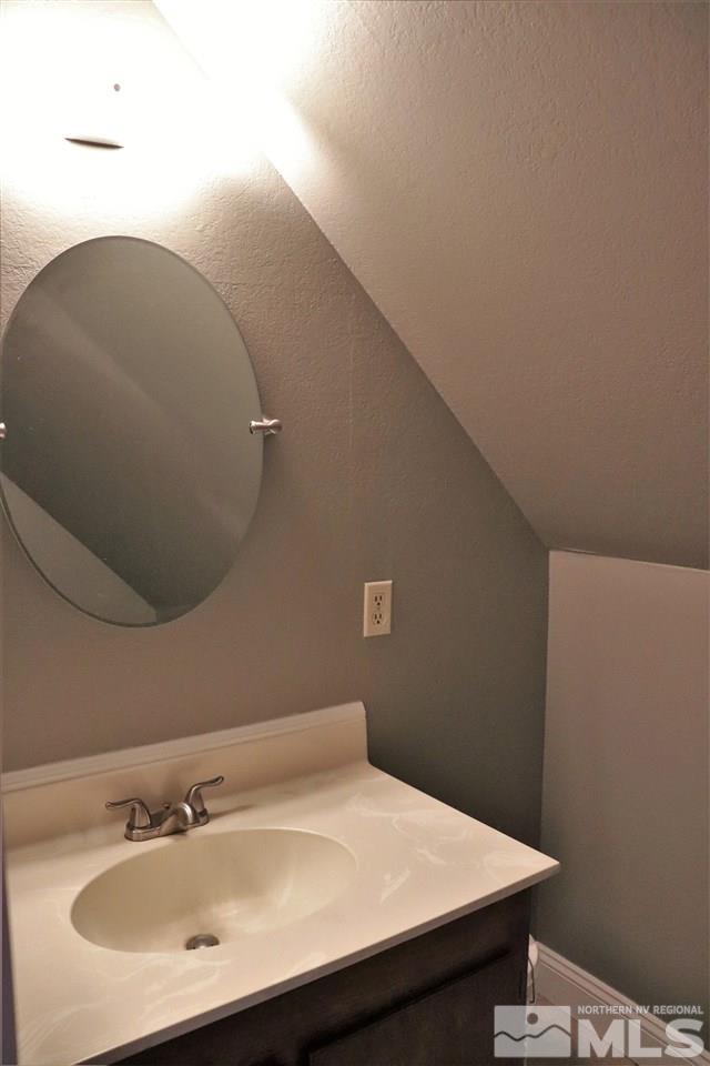 17360 Cold Springs Drive Reno, NV 89508 - Photo 9 of 16 a bathroom with a sink and a mirror