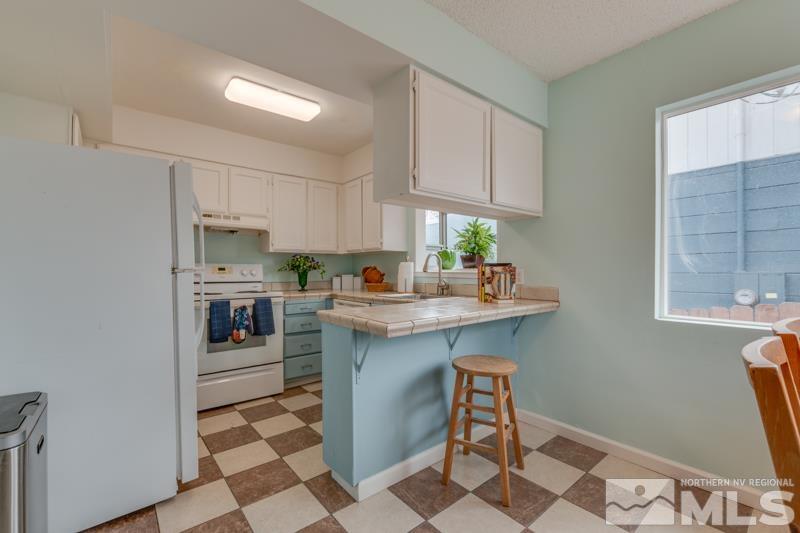 1340 Ralston Street Reno, NV 89503 - Photo 7 of 33 a kitchen with stainless steel appliances a sink a stove a refrigerator and cabinets