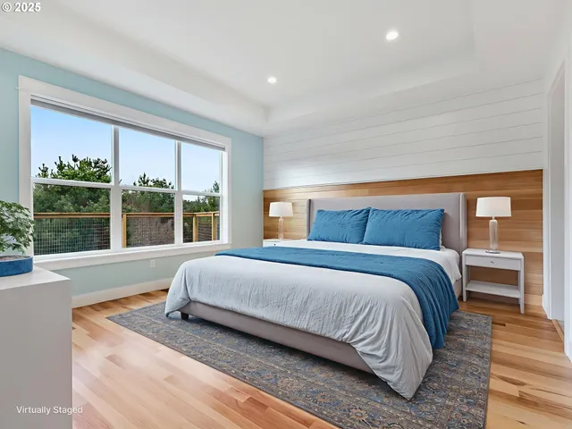 a bedroom with a large bed and a large window