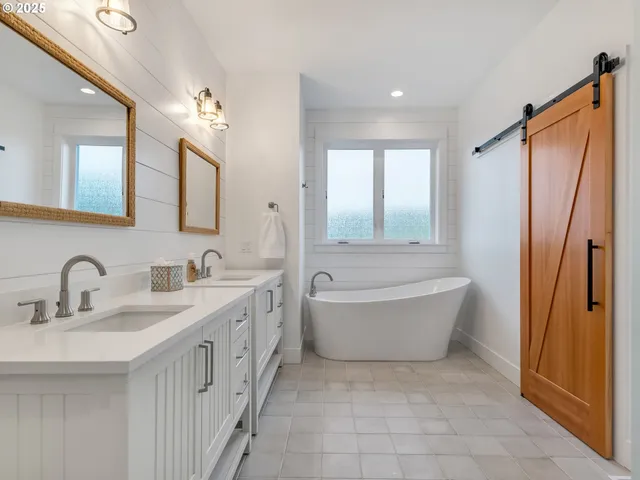 a bathroom with a tub sink and mirror