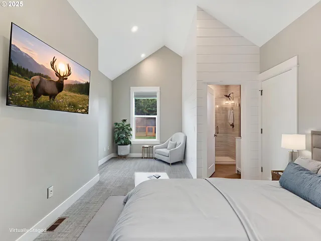 a bedroom with a bed and glass wall