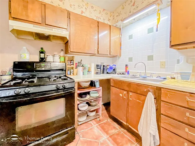 a kitchen with stainless steel appliances a stove a sink and a microwave