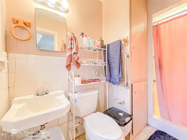 a white toilet sitting next to a bathroom sink