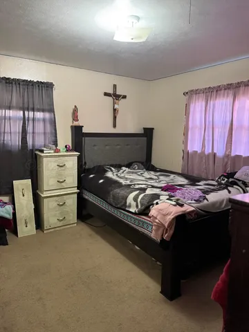 a bed room with a bed and a chair