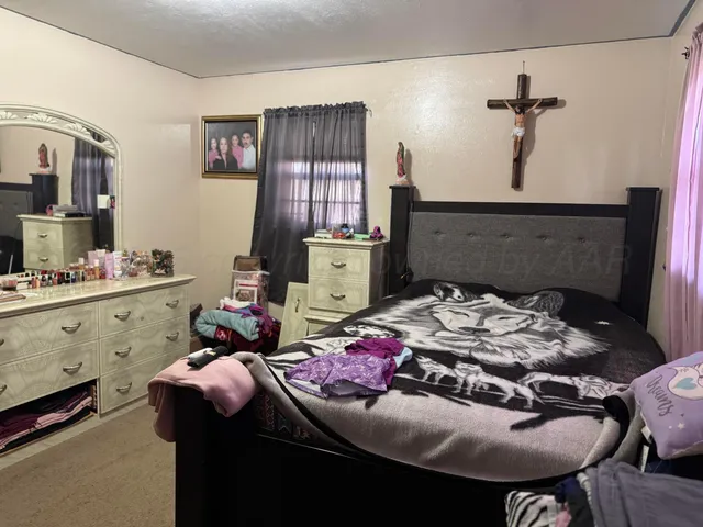 a bedroom with a bed and dresser