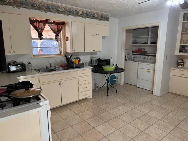 a kitchen with a sink cabinets and window
