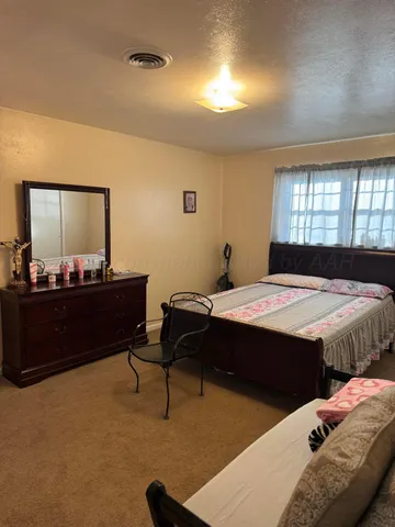 a bedroom with a bed and a dresser