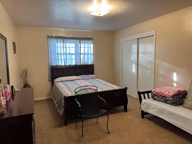 a bedroom with a bed and a lamp with window