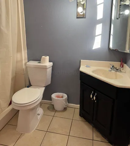 a bathroom with a sink toilet and mirror