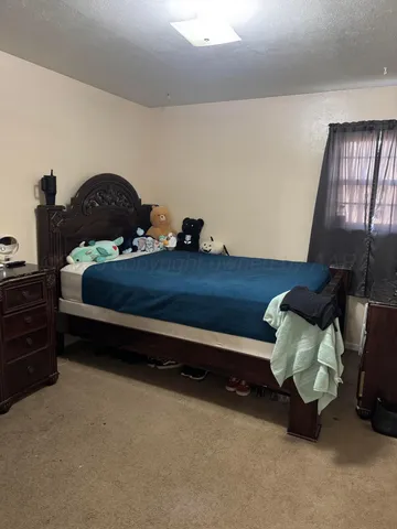 a bed room with furniture and a lamp