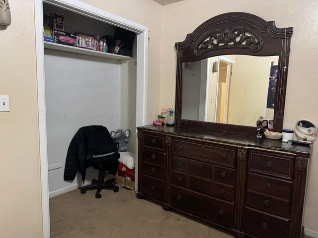 a view of a hallway with workspace and a mirror