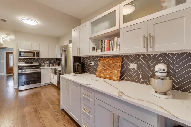 a kitchen with stainless steel appliances granite countertop a sink and a stove