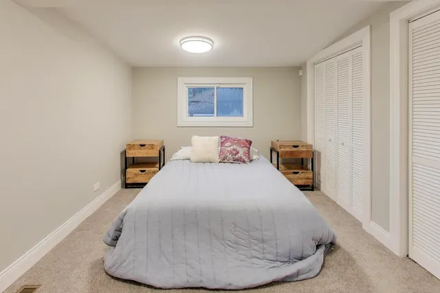 a bedroom with a bed and a night stand