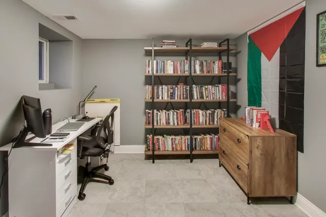 a view of a workspace with furniture and a bookshelf