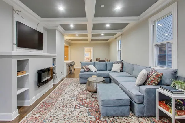 a living room with furniture fireplace and flat screen tv