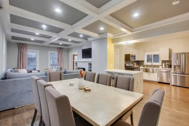 a large white kitchen with lots of counter space dining table and chairs