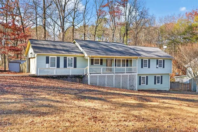 a house with large trees in front of it
