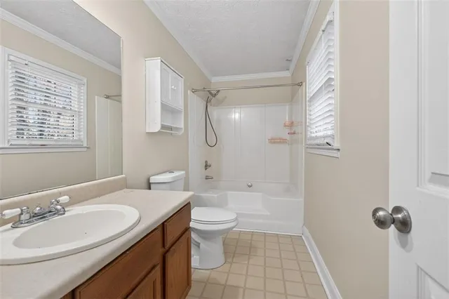 a bathroom with a double vanity sink toilet mirror and shower