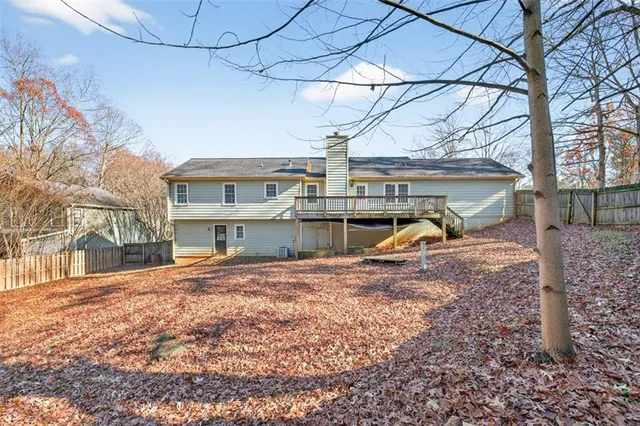 a view of a house with a yard and sitting area
