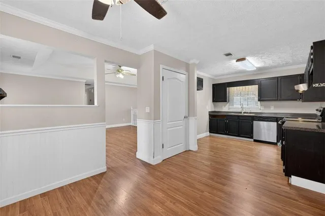 a large kitchen with cabinets and wooden floor