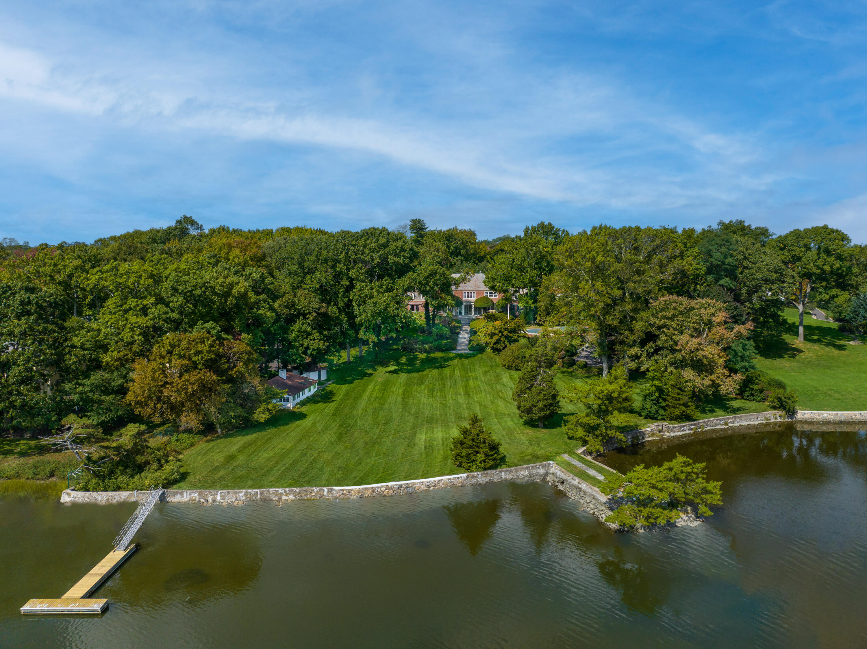 an aerial view of a houses with a yard