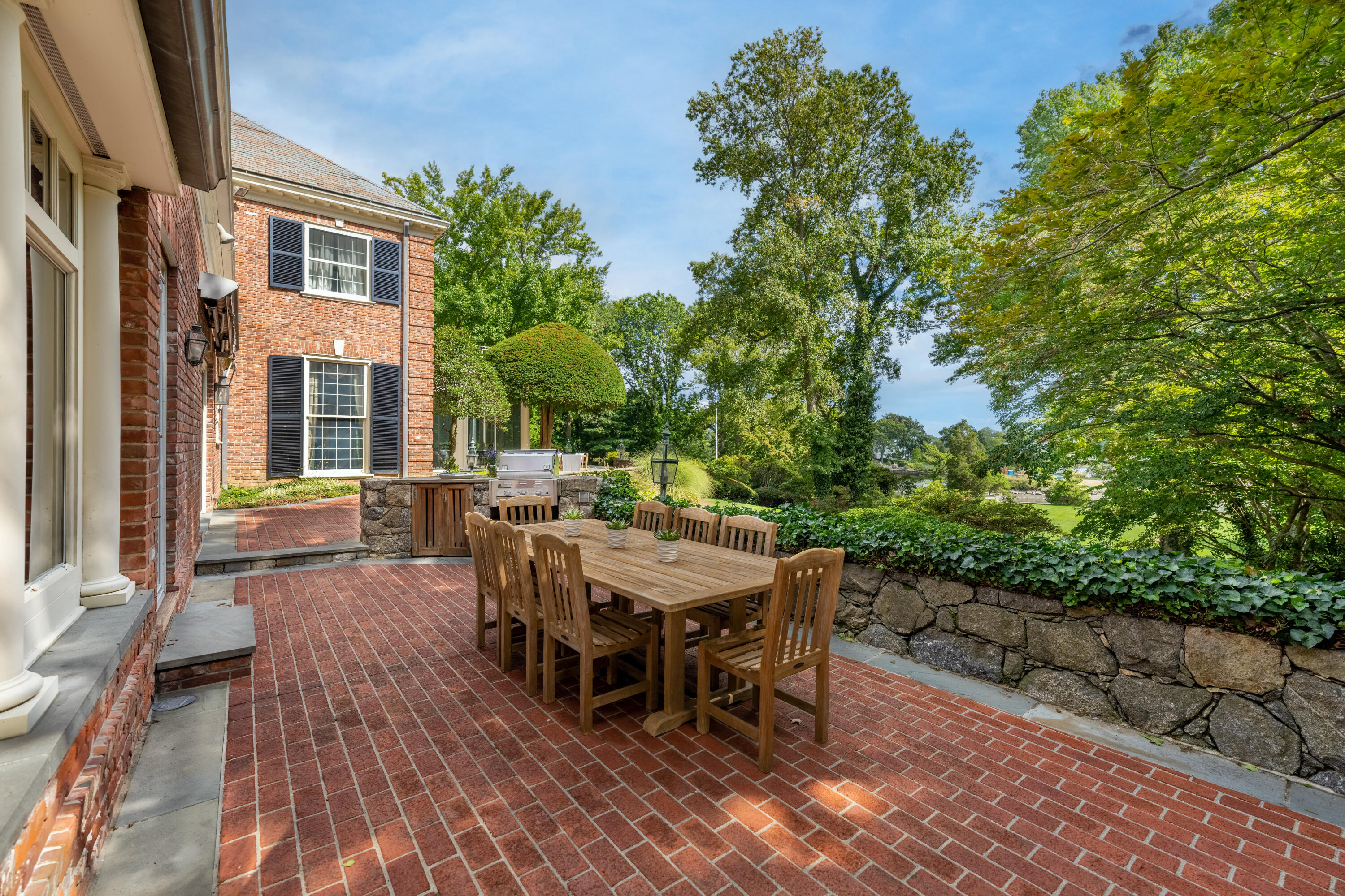 1 Runkenhage Road Darien, CT 06820 - Photo 30 of 33 a view of a patio with table and chairs with wooden floor and plants