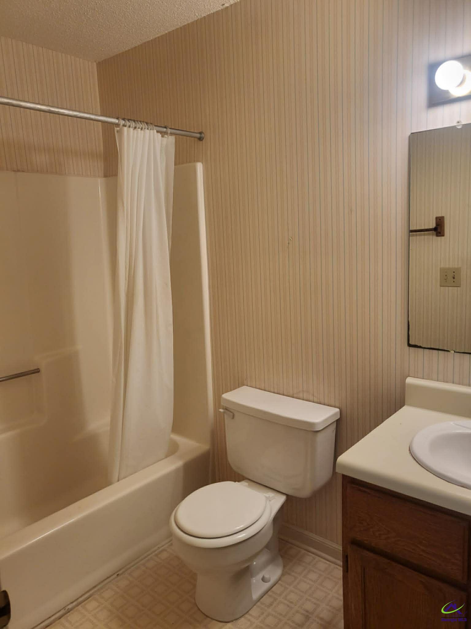 4472 Club Trace Macon, GA 31210 - Photo 8 of 10 a white toilet sitting next to a bathroom sink and a shower