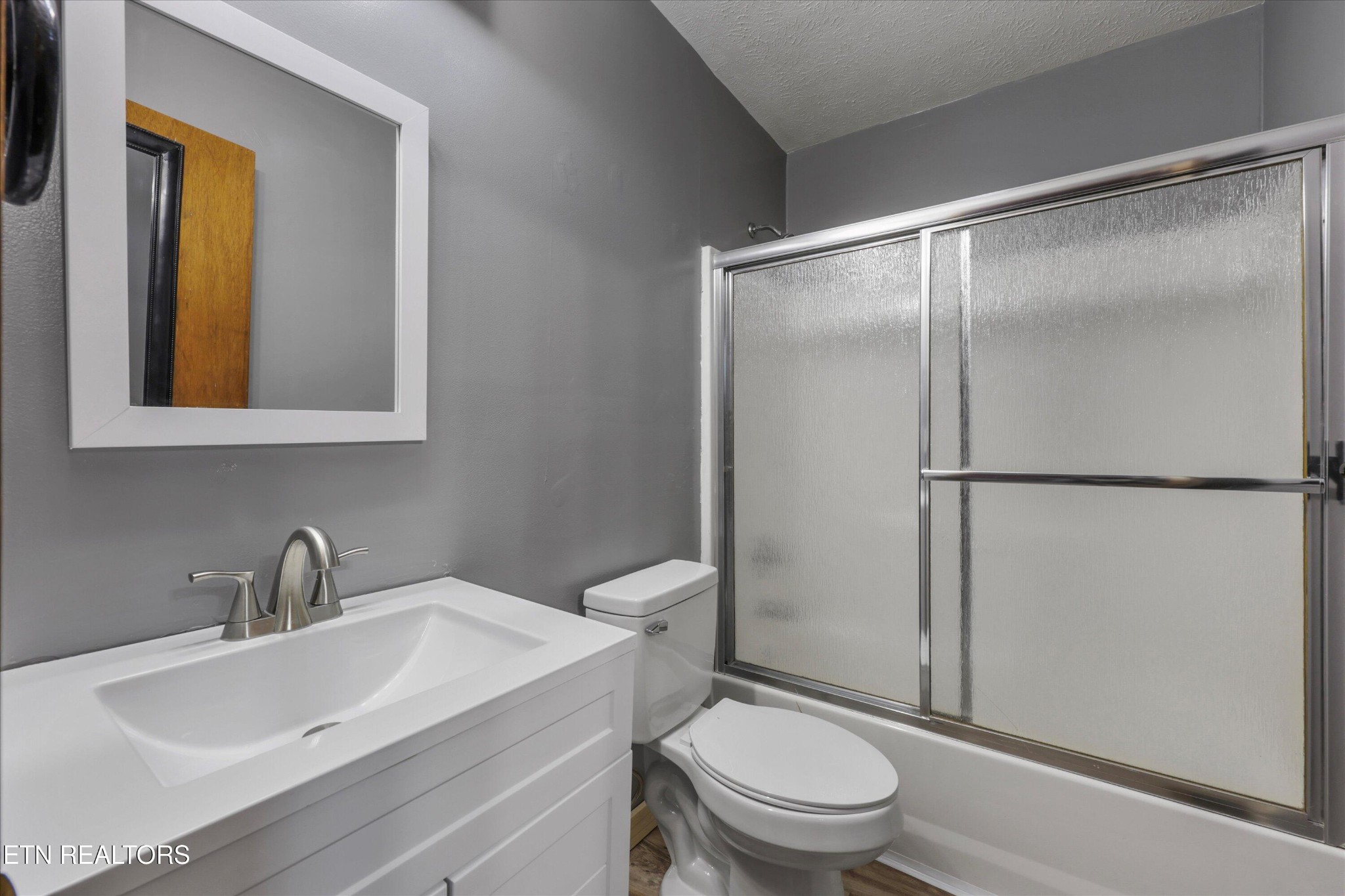 47 Paint Rock Ferry Road Kingston, TN 37763 - Photo 15 of 38 a bathroom with a toilet a sink and a mirror