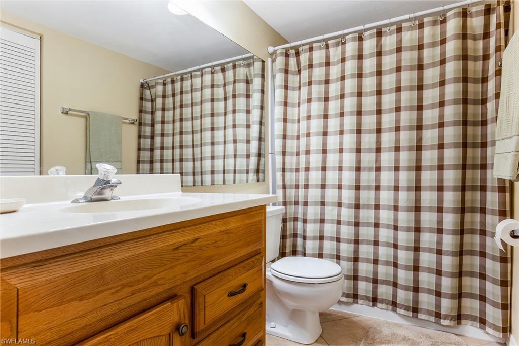 1075 Foxfire Lane, Unit 103 Naples, FL 34104 - Photo 15 of 20 a bathroom with a sink toilet and shower