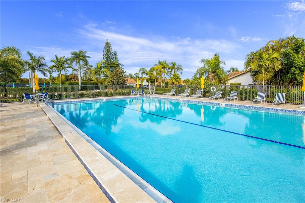 1075 Foxfire Lane, Unit 103 Naples, FL 34104 - Photo 17 of 20 a view of swimming pool with outdoor seating