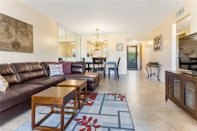 a living room with furniture a dining table and a flat screen tv