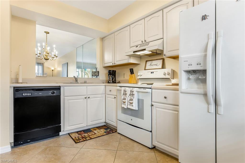 1075 Foxfire Lane, Unit 103 Naples, FL 34104 - Photo 8 of 20 a kitchen with cabinets and appliances