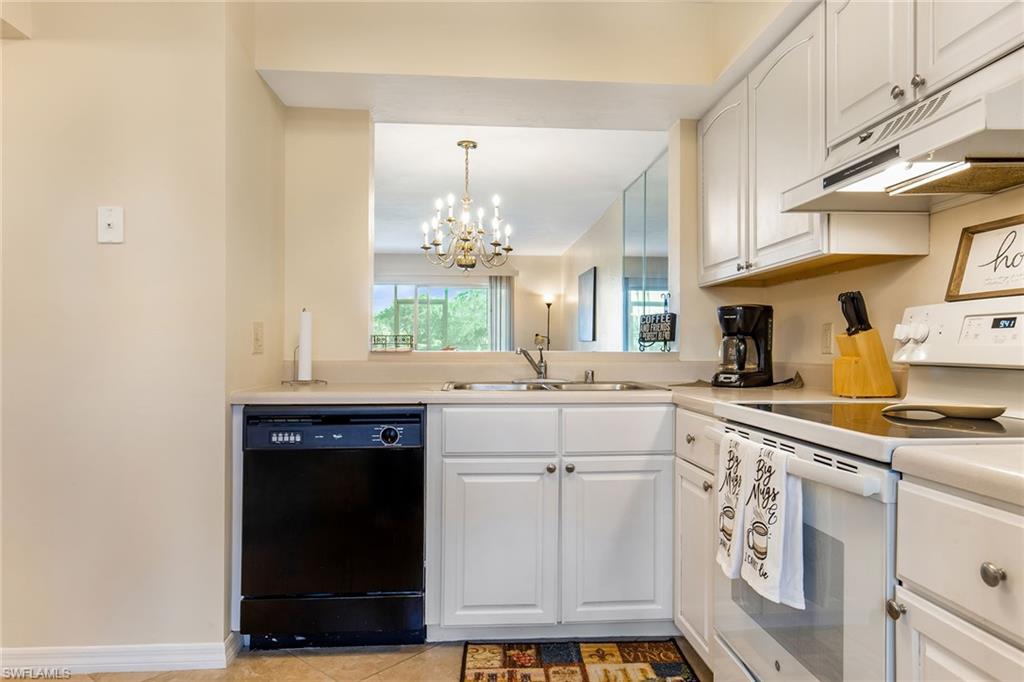 1075 Foxfire Lane, Unit 103 Naples, FL 34104 - Photo 9 of 20 a kitchen with cabinets and window