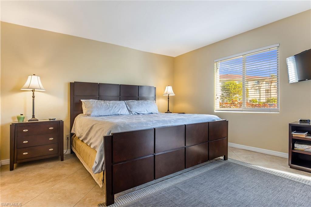 1075 Foxfire Lane, Unit 103 Naples, FL 34104 - Photo 10 of 20 a bedroom with a bed and a closet
