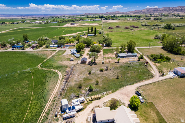 1043 East 4000th Street South Vernal, UT 84078 - Photo 23 of 31 Expansive rural property featuring a mix of green agricultural fields, scattered residential structures, and mature trees