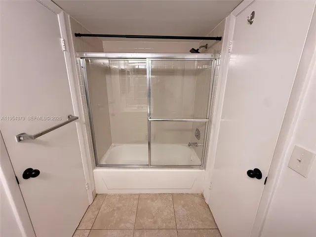 a bathroom with a glass shower door