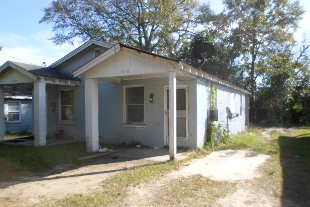 a view of a house with a yard covered in snow