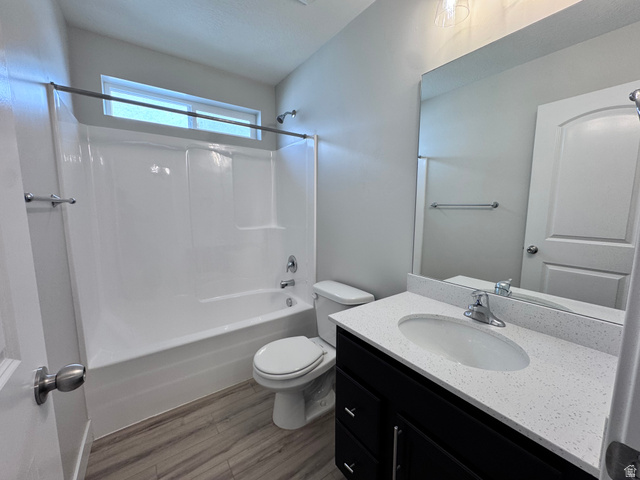 12339 Remy Road, Unit 422 Herriman, UT 84096 - Photo 8 of 36 Full bathroom featuring vanity, shower / washtub combination, and dark wood-style flooring